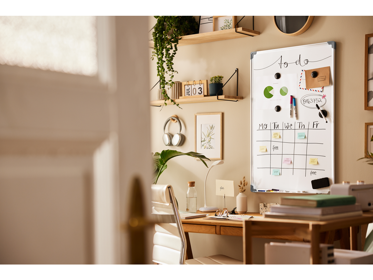 A home office with a whiteboard displaying a 'to do' list and calendar, featuring Crelando accessories.