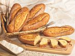 Loaves and slices of bread in a wicker basket.