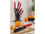 Berlinger Haus knife set with red handles, oranges, and dried fruit on a kitchen counter.