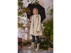 Woman in beige raincoat and leopard print boots under a black umbrella.