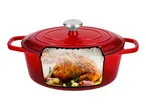 Red cast iron Dutch oven with a roasted chicken inside, surrounded by herbs and vegetables.