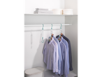 Several shirts hang on space-saving hangers in a white closet.