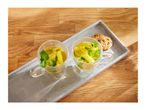 Two glass mugs of lemon and mint tea with cookies on a gray tray.