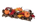 Autumnal centerpiece with pumpkins, pinecones, berries, and leaves on a wooden base.