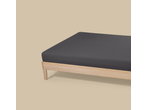 Livarno Jersey Fitted Sheet in dark grey on a light wooden bed frame.