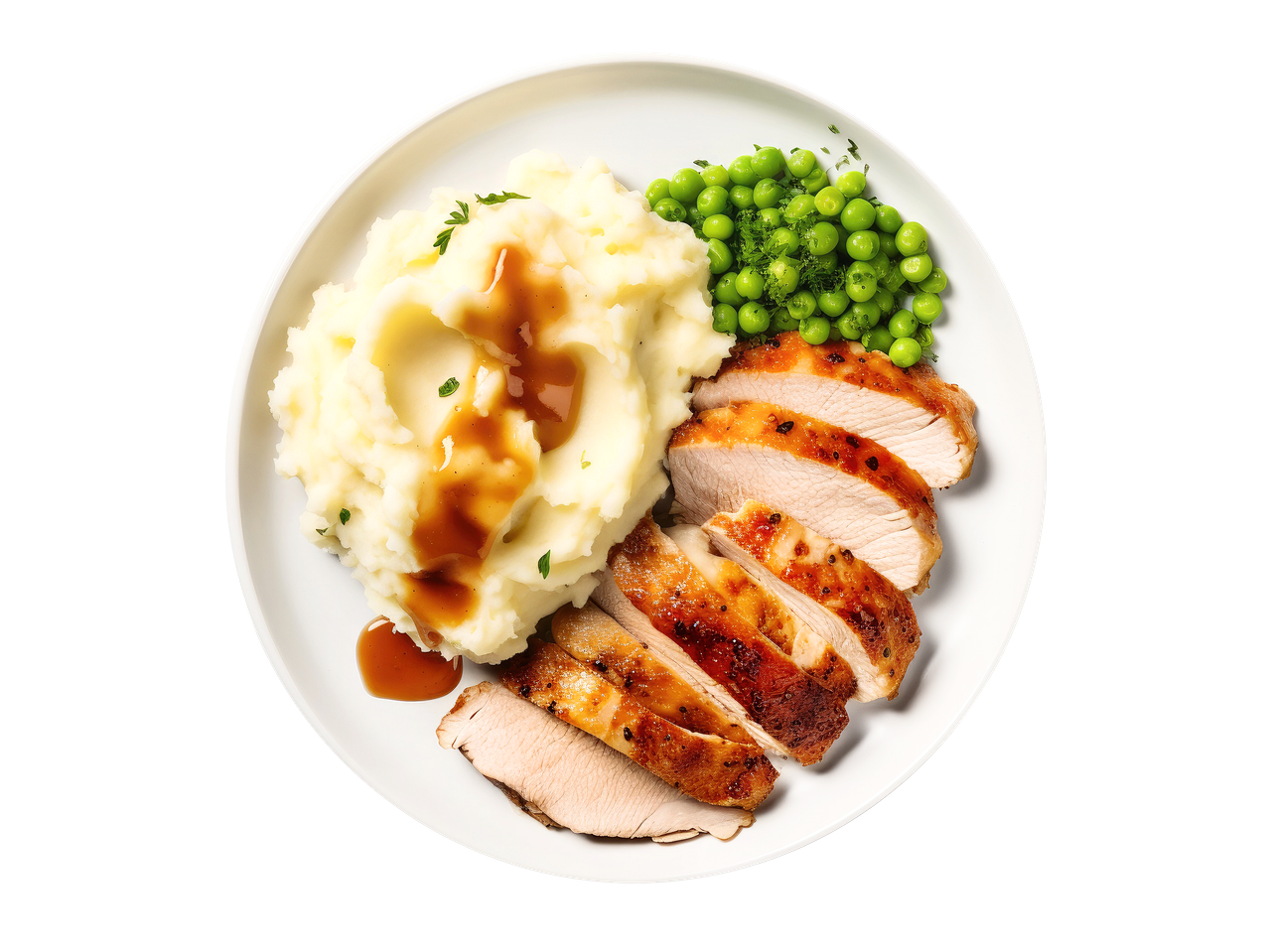 Sliced turkey breast with mashed potatoes, gravy, and green peas on a white plate.
