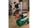 Man inflating car tire with a Parkside® Silent compressor PSKO 248.