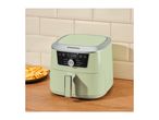 Light green air fryer on a wooden counter with a plate of fries, displaying '175°C'.