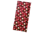 Crelando wrapping paper with Christmas ornaments, candy canes, and puddings on a red background.