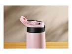 Close-up of a pink water bottle with a black lid and handle on a wooden surface.