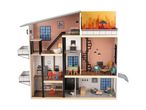 Multi-story dollhouse with furniture, accessories, and two doll figures.