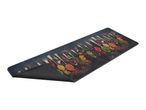 Kitchen mat with a print of various spices in spoons on a dark background.