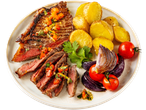 Grilled steak with chimichurri, roasted potatoes, red onions, and cherry tomatoes on a plate.