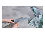 A person sharpening a kitchen knife with a blue ceramic sharpening rod.