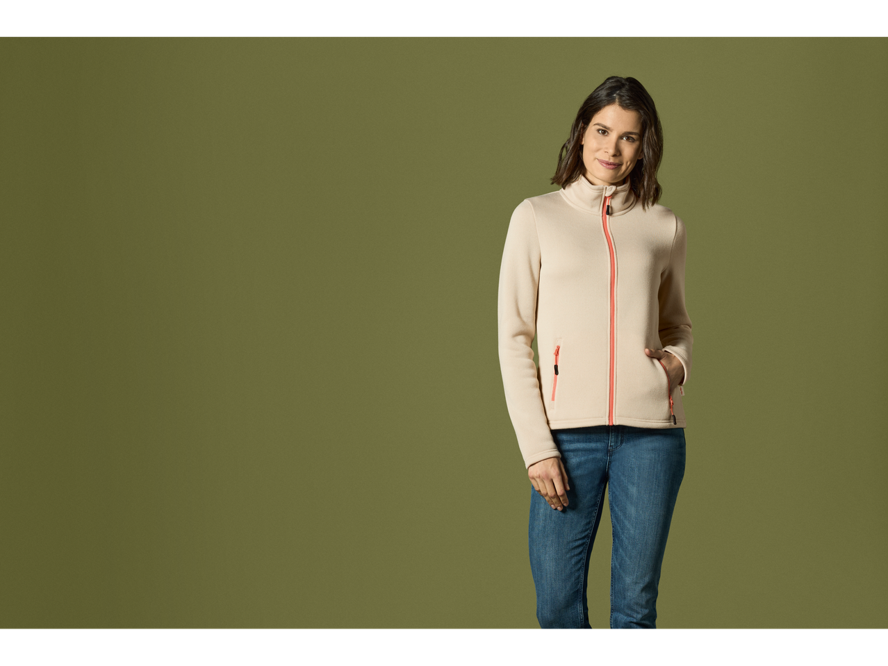 Woman in a beige fleece jacket and jeans.