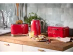 Red toaster, kettle, and bread box on a kitchen counter.