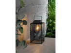 Black outdoor lantern with geometric pattern and warm light