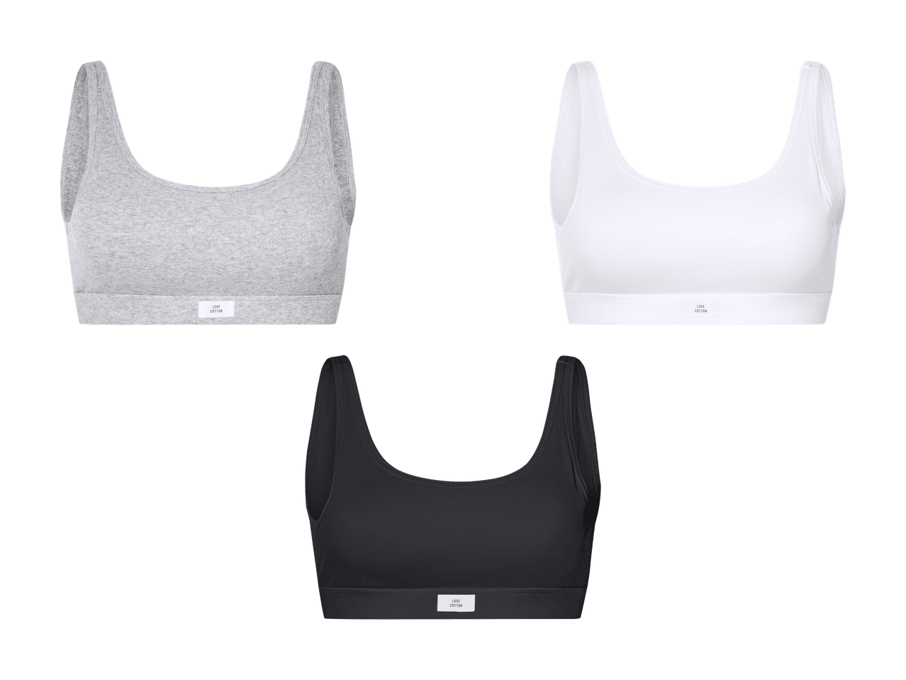 Drei gerippte Baumwoll-Sport-Tops in Grau, Weiß und Schwarz.