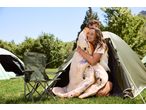 Happy campers in a CRIVIT tent, embracing with a patterned sleeping bag.