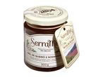 Jar of heather and wild lavender honey with a decorative tag featuring a mountain landscape.