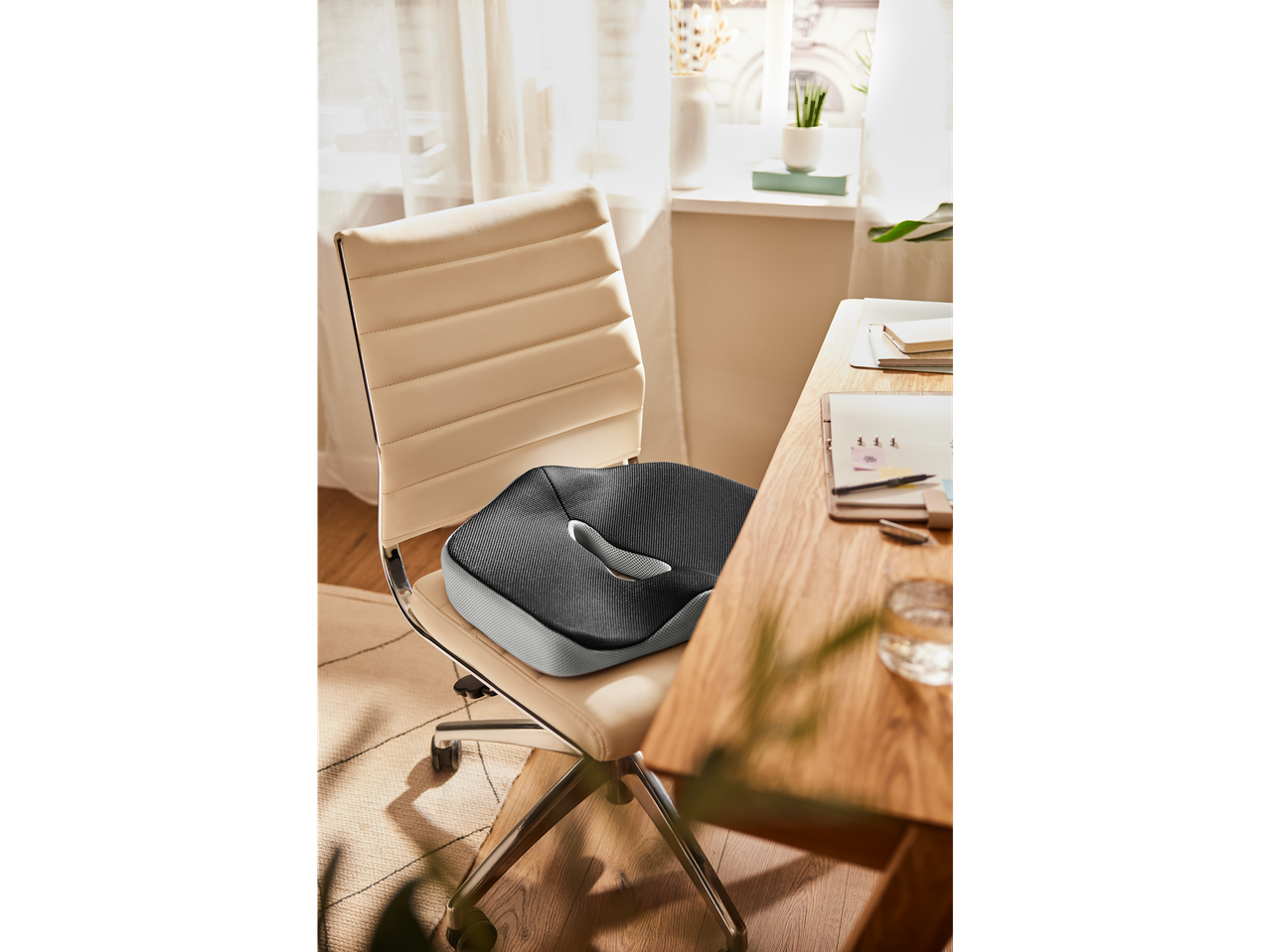 Office chair seat cushion on a wooden desk.