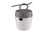 Portable camping lantern with a grey top and white body, hanging from a dark branch.