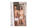 Man in white boxers and woman in light pink bralette and briefs standing together.