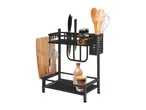 Black metal kitchen organizer with knives, wooden utensils, spices, and a cutting board.