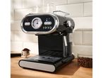 Black and chrome espresso machine with a temperature gauge and coffee beans.