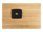 Top-down view of a black square-shaped kitchen scale on a light wooden surface.