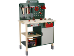 A green and natural wood toy workbench with various tools, including a saw, hammer, and drill.
