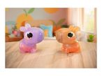 Two colorful, translucent animal toys with large eyes on a wooden surface in a bright room.