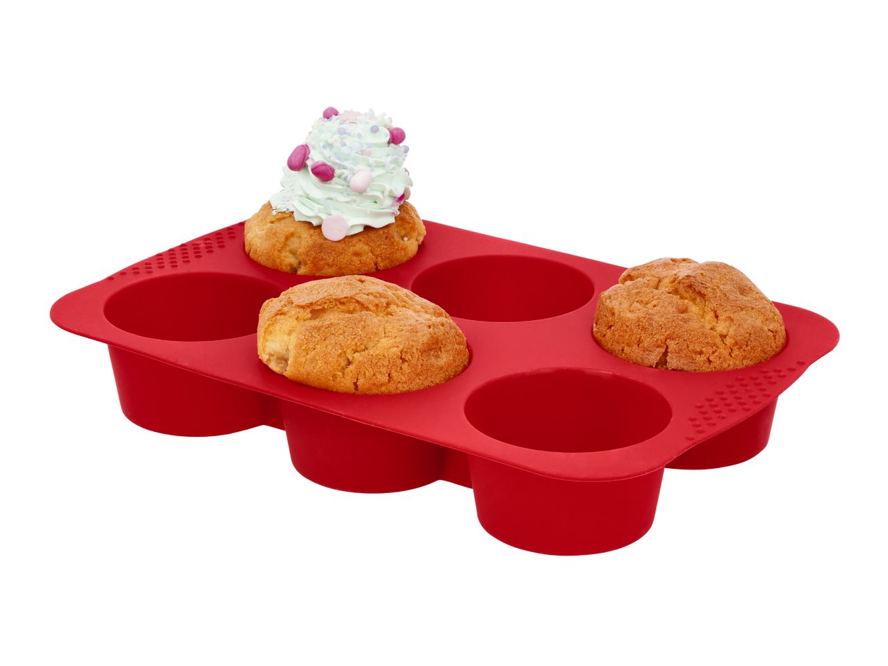 Red silicone muffin tray with three muffins, one topped with mint frosting and sprinkles.