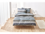 Grey and blue striped bedding on a bed.