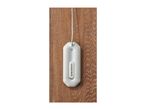 A white, oval-shaped mini dehumidifier with a power cord on a wooden surface.