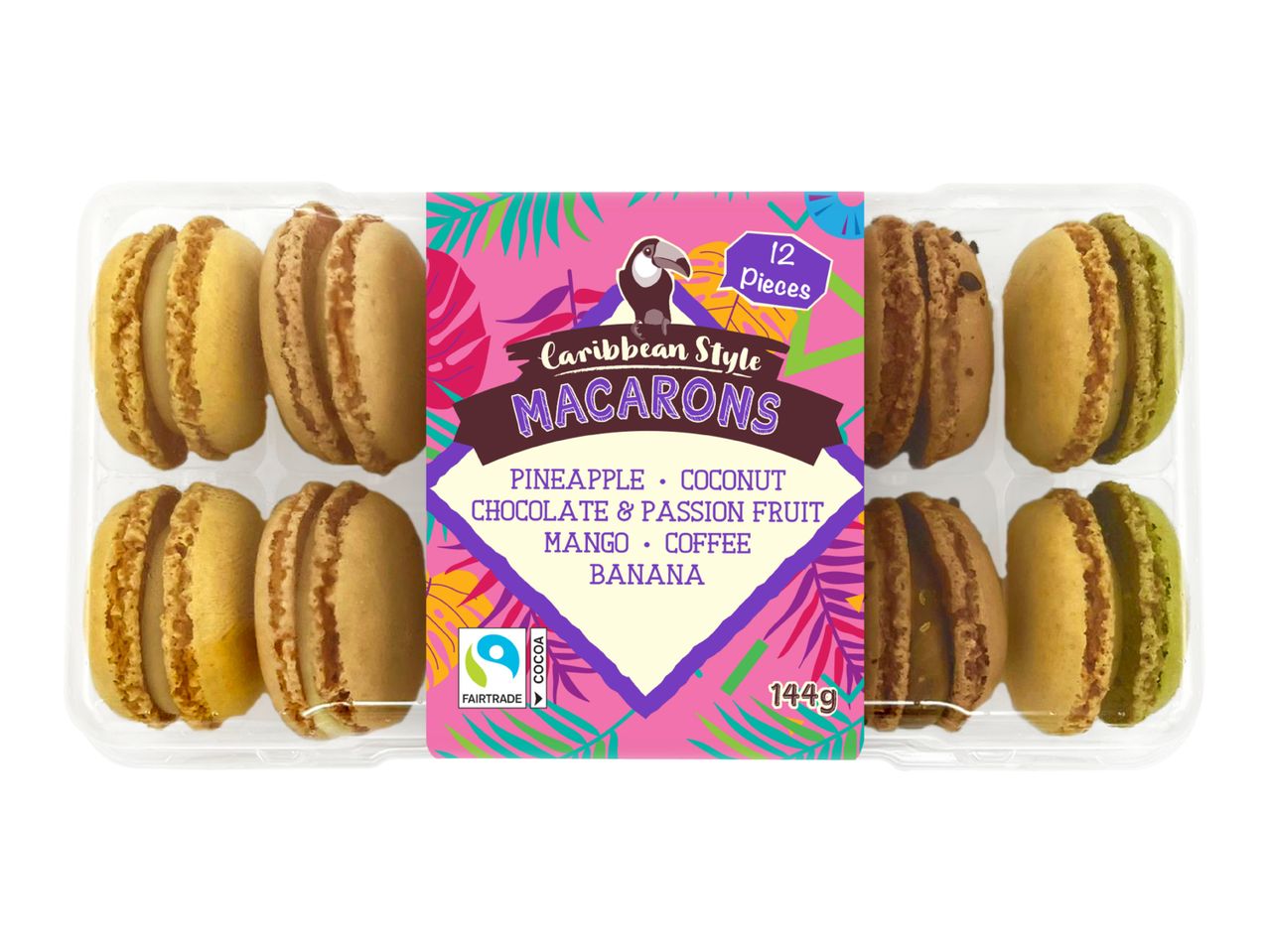 A clear plastic tray of 12 Caribbean-style macarons in various flavors, including pineapple, coconut, chocolate, passion fruit, mango, coffee, and banana.