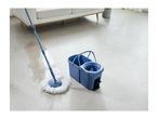 Blue spin mop and bucket cleaning a light-colored floor in a living room.