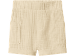 Cream-colored muslin shorts with an elastic waistband and two front pockets.