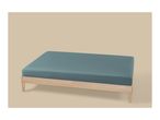 A wooden bed frame with a teal fitted sheet on a beige background.