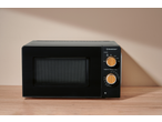 SILVERCREST® 700W Microwave with power and timer dials on a wooden surface.