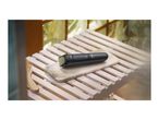 Beard trimmer on a marble tray, with a wooden comb nearby, in a bright bathroom.
