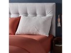 Copper Sleep pillow on a bed with terracotta bedding.