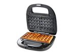 Open waffle maker with two golden-brown waffles inside.
