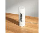 A small white fan on a wooden table.