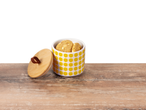 Cookies in a lemon-patterned jar with bamboo lid.