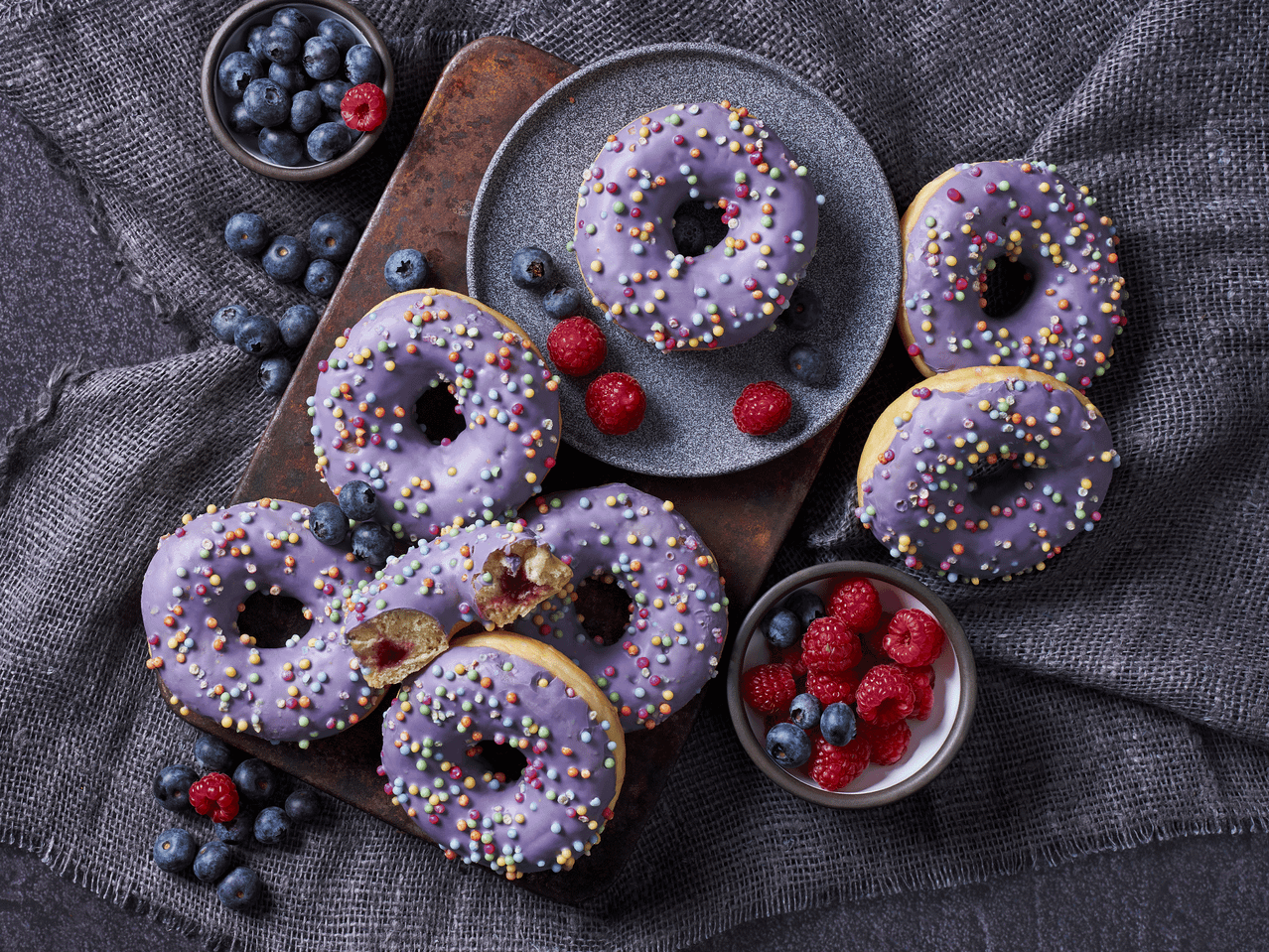 Lillad sõõrikud puistete, mustikate ja vaarikatega hallil kangal.