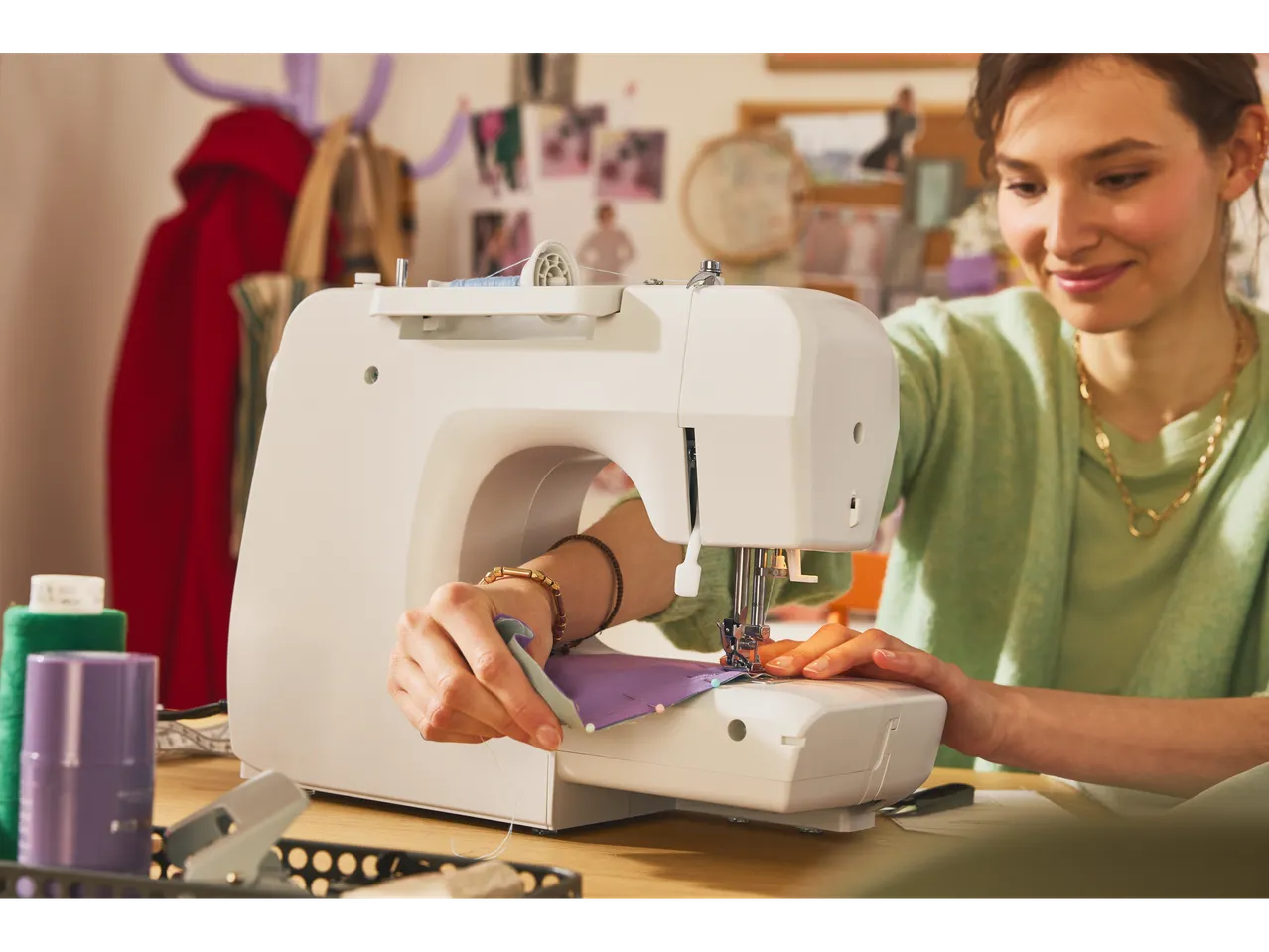 Woman sewing with a LIVARNO home sewing machine, focused on her craft.