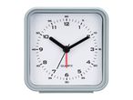 A gray square alarm clock with a white face and black hands.