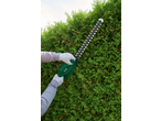 Person using a Parkside® 450W Electric Hedge Trimmer to trim a green hedge.