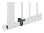 Close-up of a white baby gate with a gray latch mechanism.